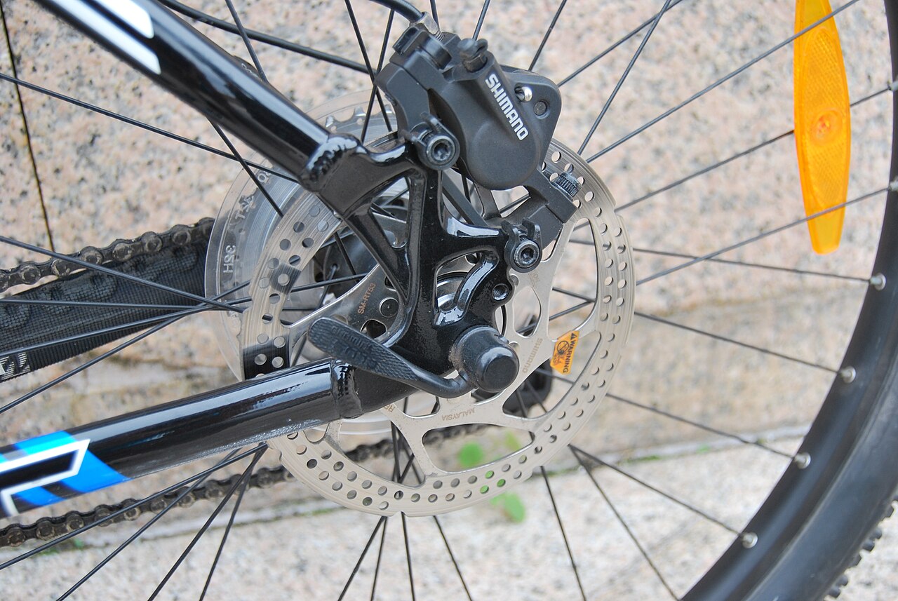 Rear disc brake caliper and rotor on a Trek bicycle wheel
