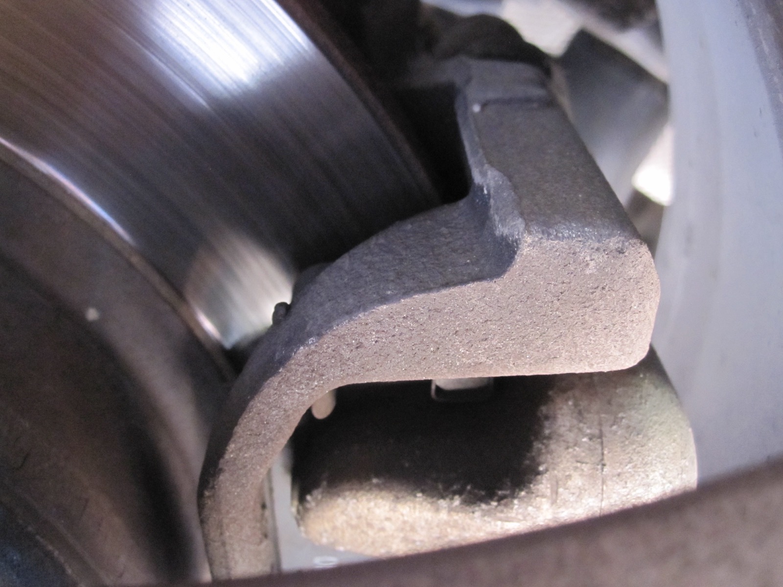 Close view of a passenger-car disc brake caliper and rotor