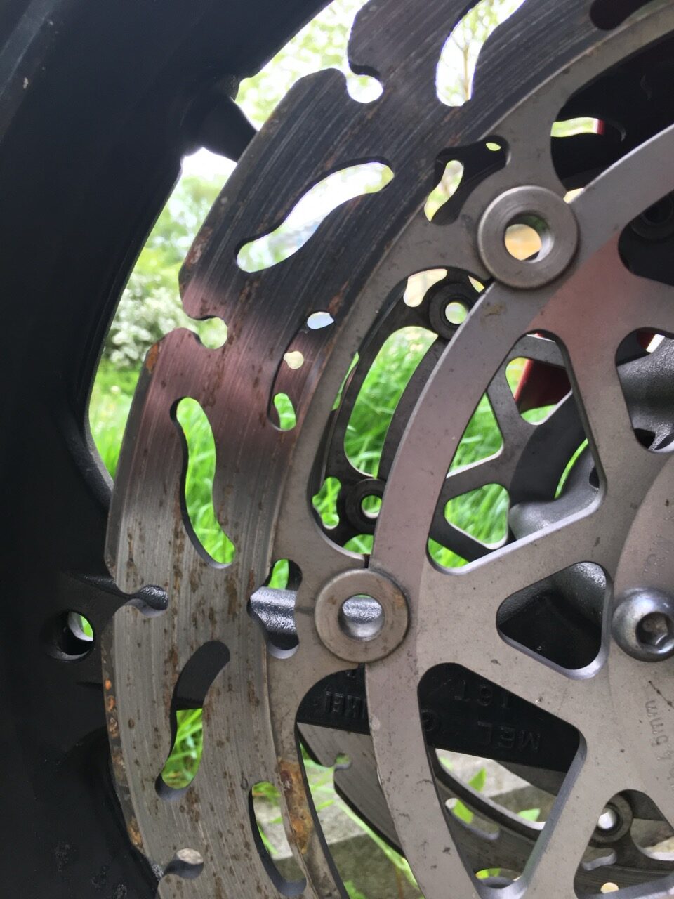 Close-up of a motorcycle front brake disc and caliper
