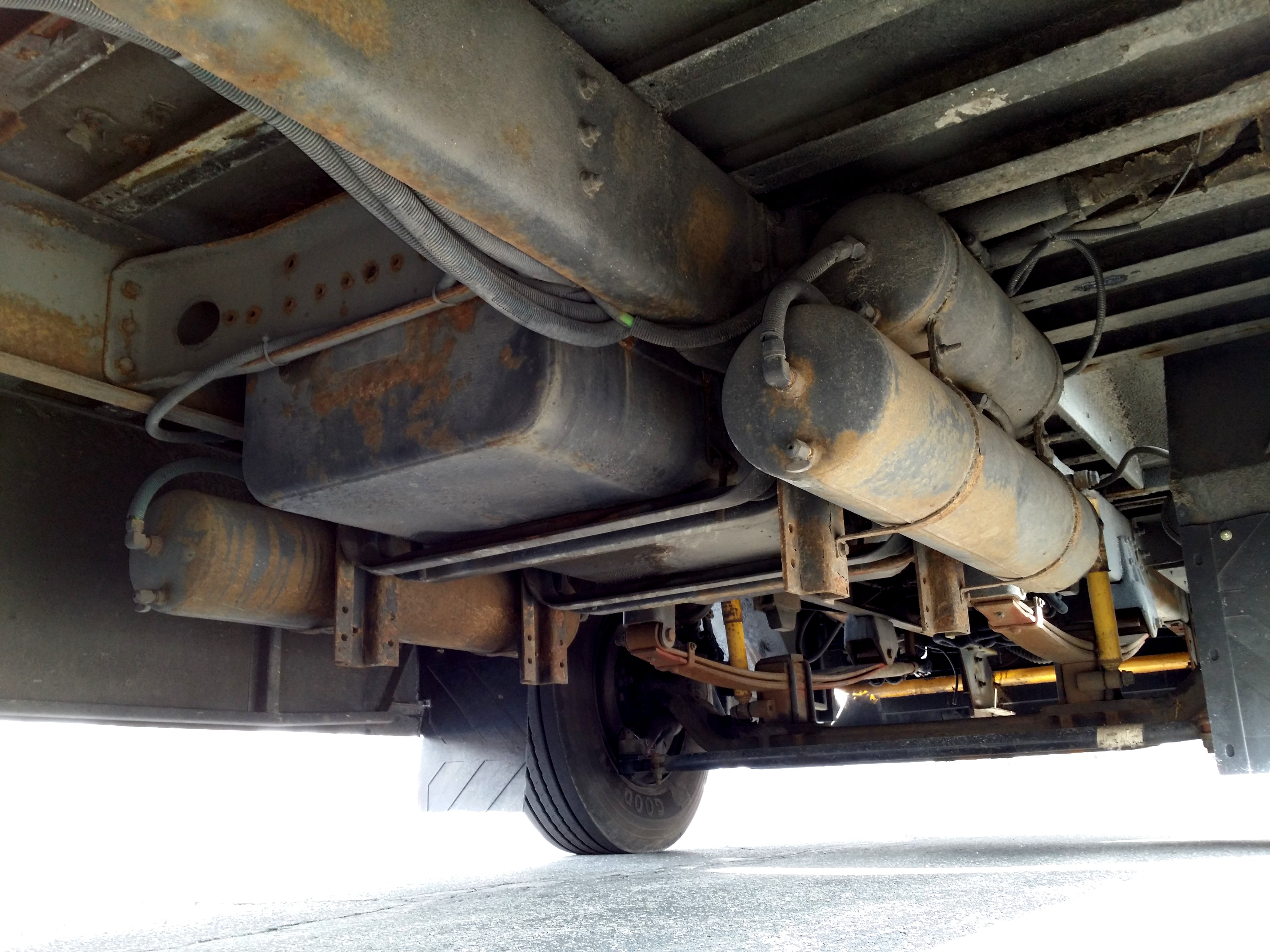 Air tanks and leaf springs under a Thomas Built school bus